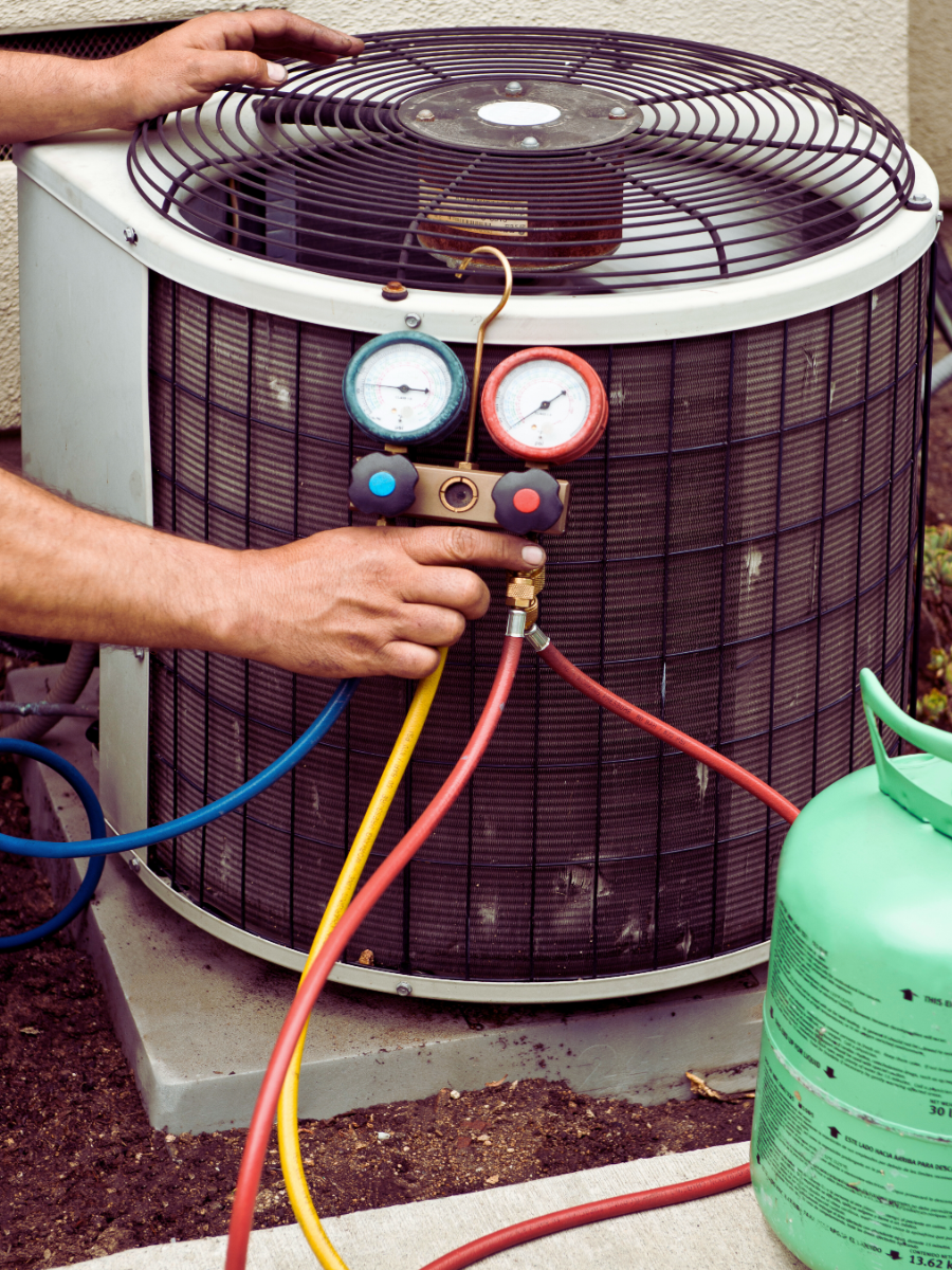 HVAC tech refilling AC unit with freon