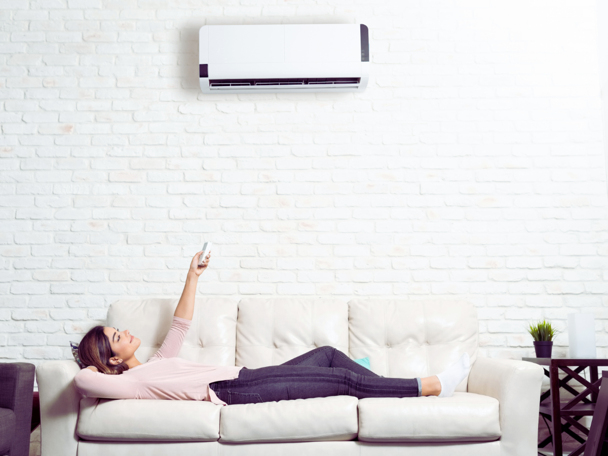Pensacola homeowner enjoying her ductless mini split system year round from comfort of her couch