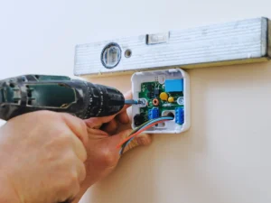 HVAC tech ensuring proper placement when installing thermostat