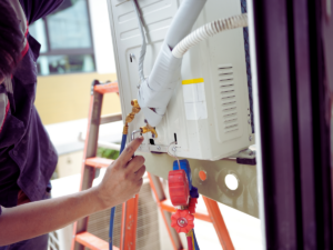 HVAC tech fixing leaking air conditioner