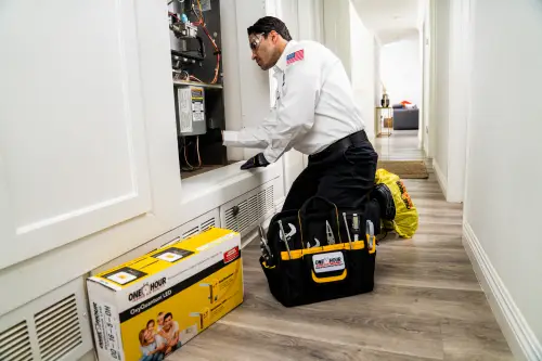 One Hour tech performing heater tune-up before winter in Pensacola, FL