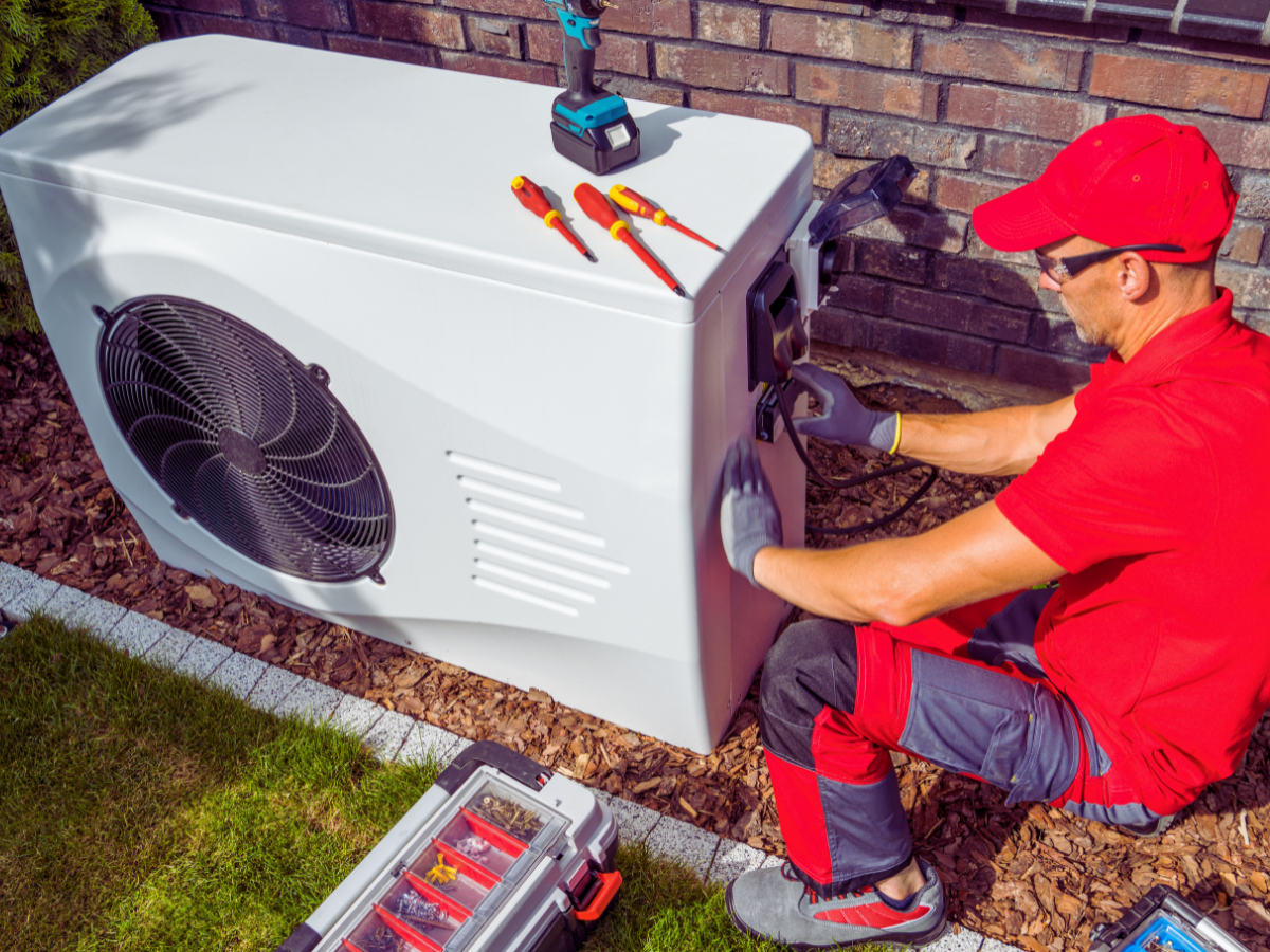 HVAC tech working on heat pump affected by Pensacola's coastal conditions